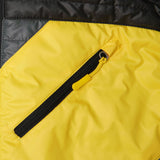 Close-up of the Hikox Vest's main black coil zipper with thumb puller and fashion yellow polyester bubble material behind the zipper.