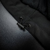 Detail view of the elastic waist tightener with a plastic stopper for adjustable fitting on the Thorvo Waistcoat.